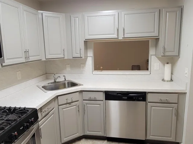 a kitchen with stainless steel appliances a refrigerator and a stove top oven