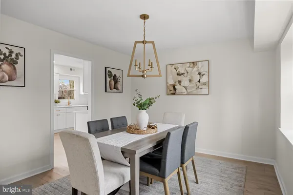 a dining room with furniture and wooden floor