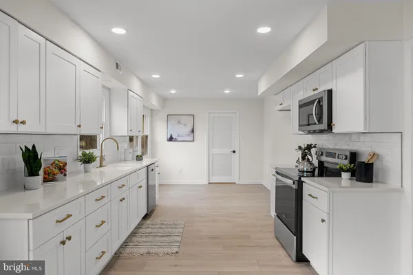 a kitchen with cabinets and window