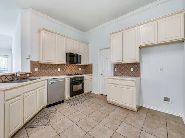 a kitchen with a stove microwave and sink