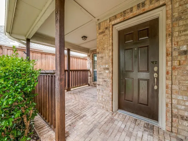 a view of a wooden door and a window