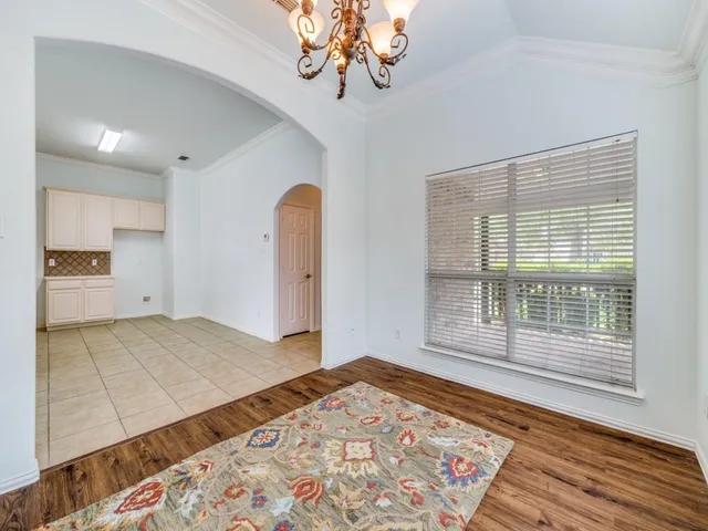 a view of a room with a window and wooden floor
