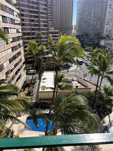 a view of a backyard with plants and outdoor seating