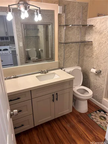 a bathroom with a toilet a sink and mirror