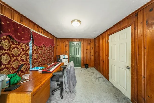 a view of a hallway with furniture and a window