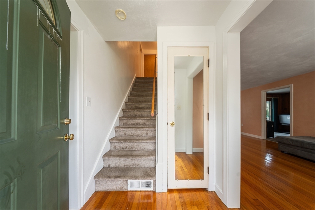 1078 Liberty Street Springfield, MA 01104 - Photo 15 of 42 a view of a hallway with wooden floor and staircase