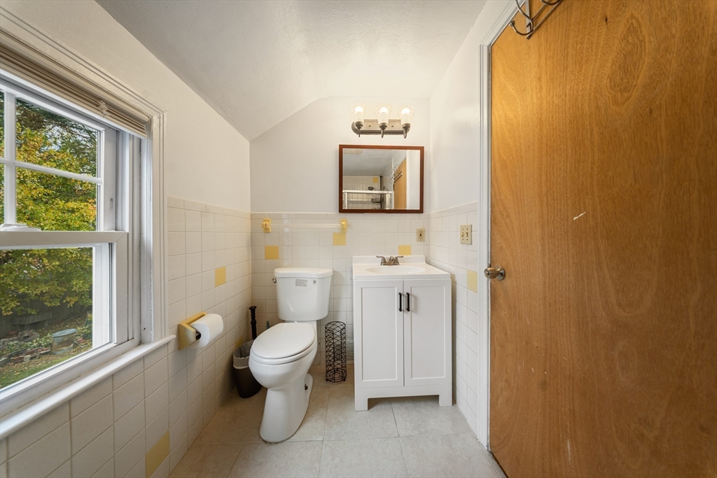 1078 Liberty Street Springfield, MA 01104 - Photo 22 of 42 a bathroom with a toilet sink and a mirror