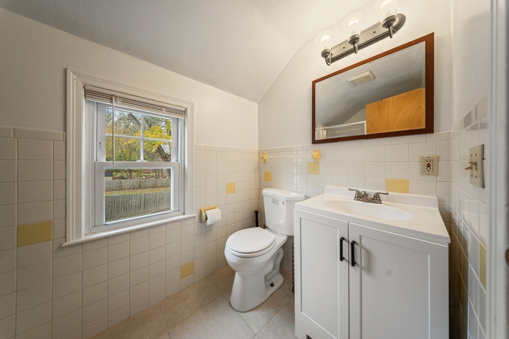 1078 Liberty Street Springfield, MA 01104 - Photo 23 of 42 a bathroom with a toilet sink and mirror