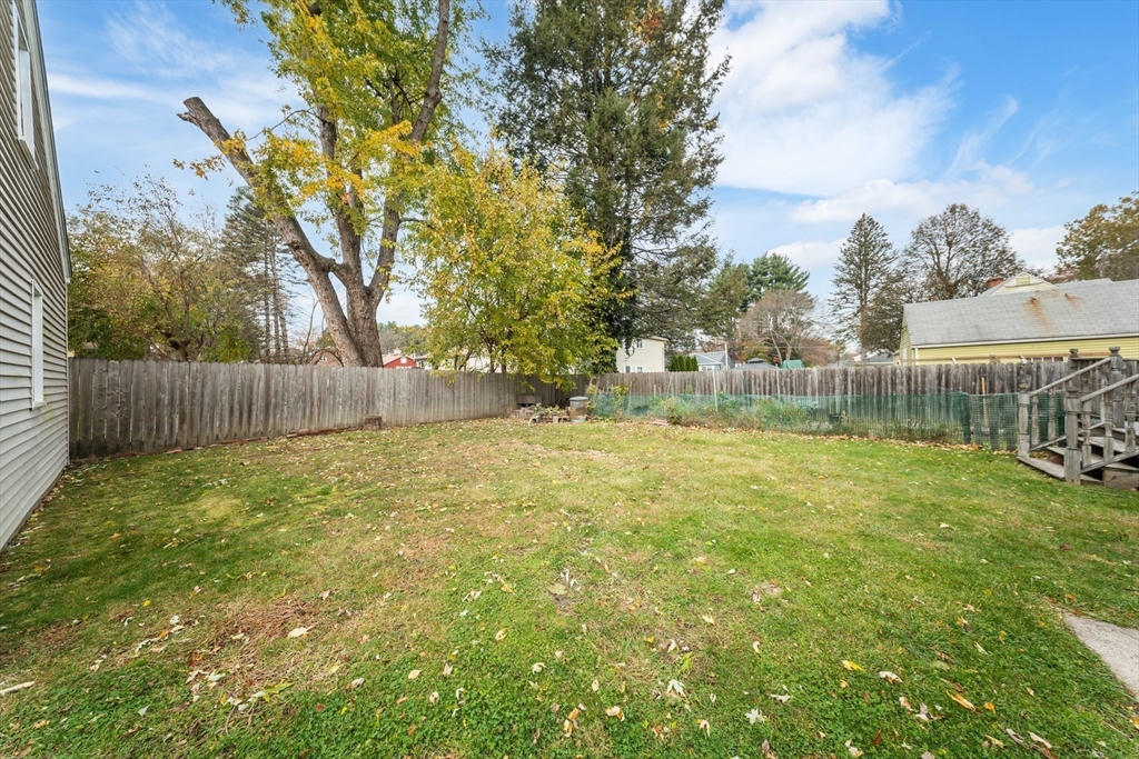 1078 Liberty Street Springfield, MA 01104 - Photo 39 of 42 a view of backyard with tree and wooden fence