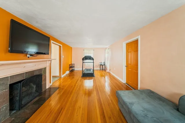 a spacious bedroom with a bed and a flat screen tv