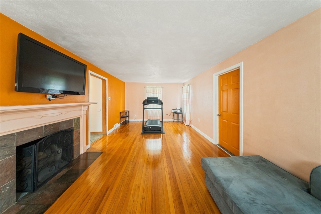 1078 Liberty Street Springfield, MA 01104 - Photo 6 of 42 a spacious bedroom with a bed and a flat screen tv