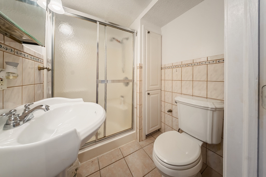 1078 Liberty Street Springfield, MA 01104 - Photo 10 of 42 a bathroom with a sink a toilet and shower