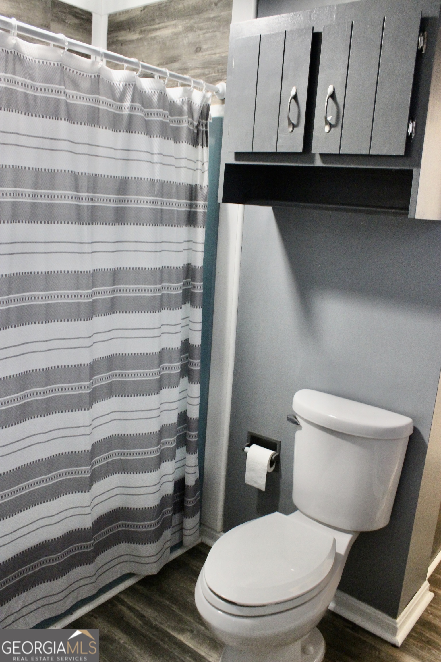 3631 Clay Circle Macon, GA 31216 - Photo 19 of 32 a white toilet sitting next to a shower curtain