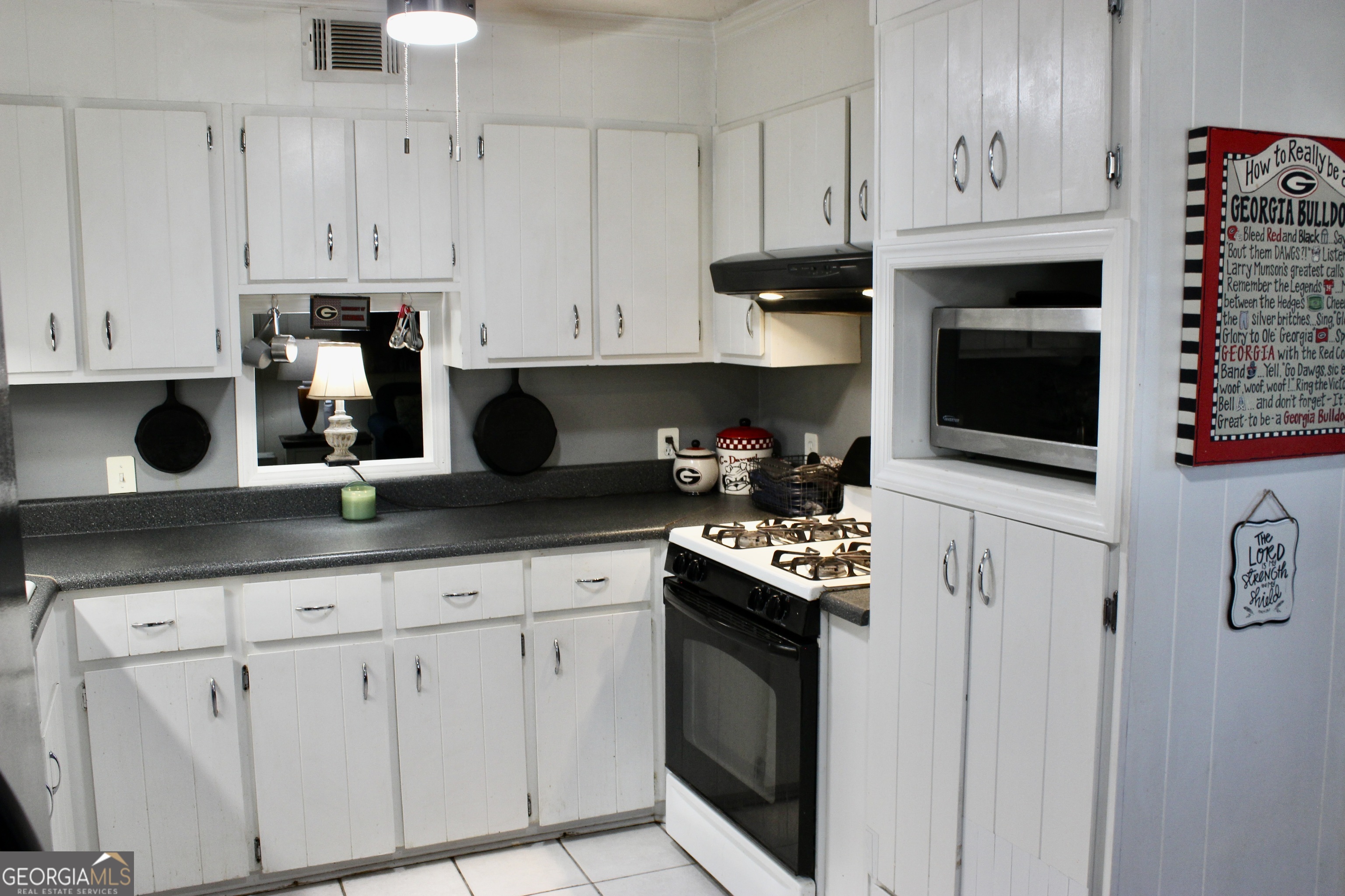 3631 Clay Circle Macon, GA 31216 - Photo 9 of 32 a kitchen with white cabinets and stainless steel appliances