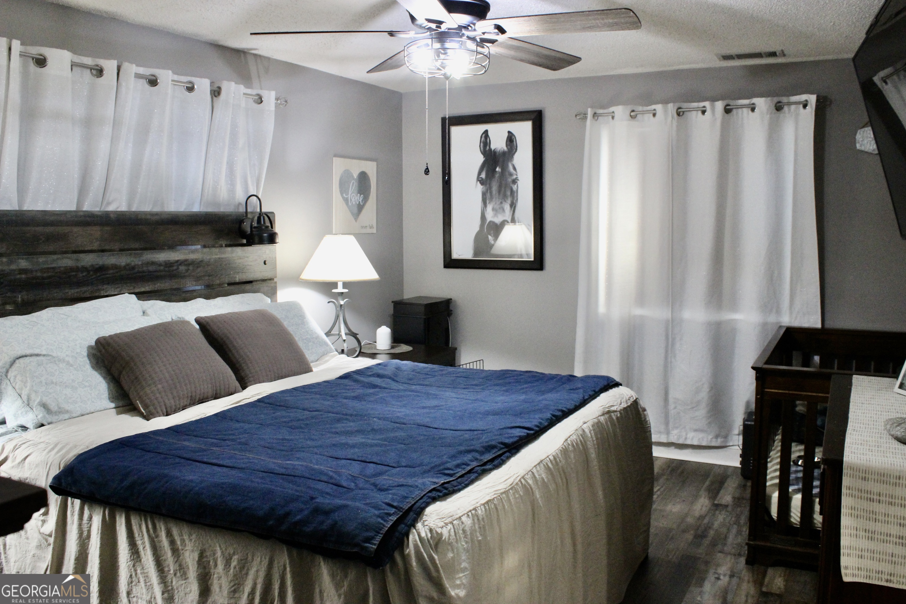 3631 Clay Circle Macon, GA 31216 - Photo 10 of 32 a bedroom with a bed and a chandelier