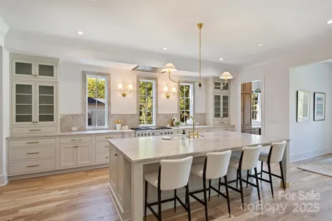 a kitchen with center island table and chairs