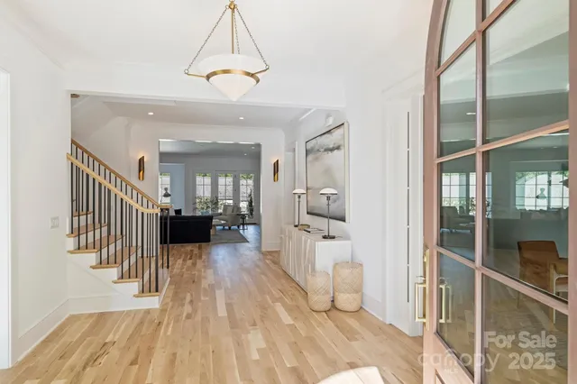 a view of a hallway with wooden floor and a livingroom view