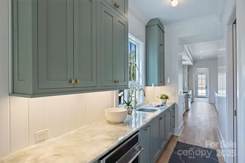 a hallway with sink and mirror