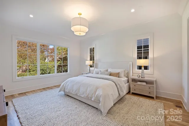 a bedroom with a bed and a large window