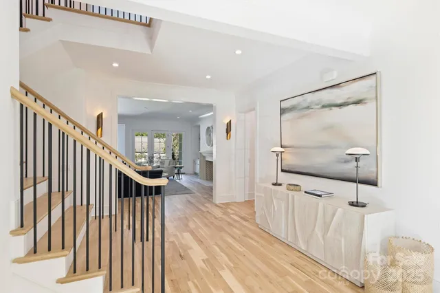 a view of entryway and hall with wooden floor