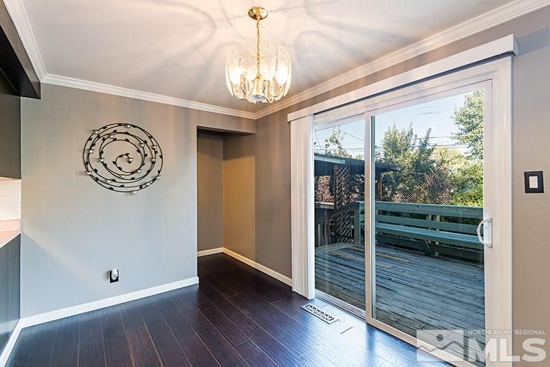 1430 Alturas Avenue Reno, NV 89503 - Photo 5 of 15 a view of a hallway with wooden floor and a chandelier