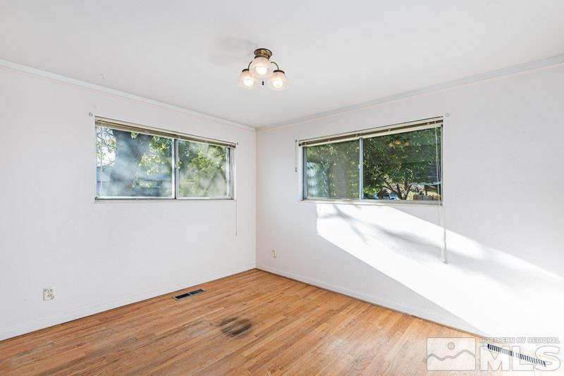 1430 Alturas Avenue Reno, NV 89503 - Photo 8 of 15 a view of an empty room with wooden floor and a window