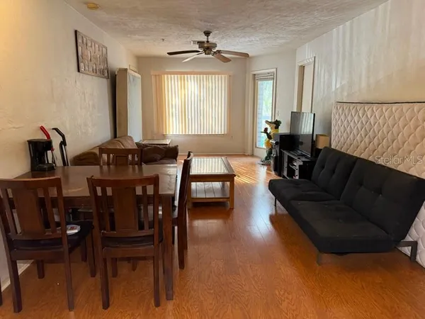 a living room with furniture and wooden floor