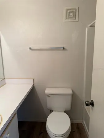 a white toilet sitting next to a shower