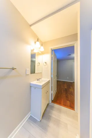 a bathroom with a granite countertop sink and mirror