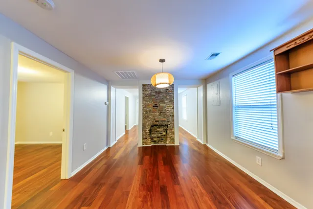 a view of a room with wooden floor closet and windows