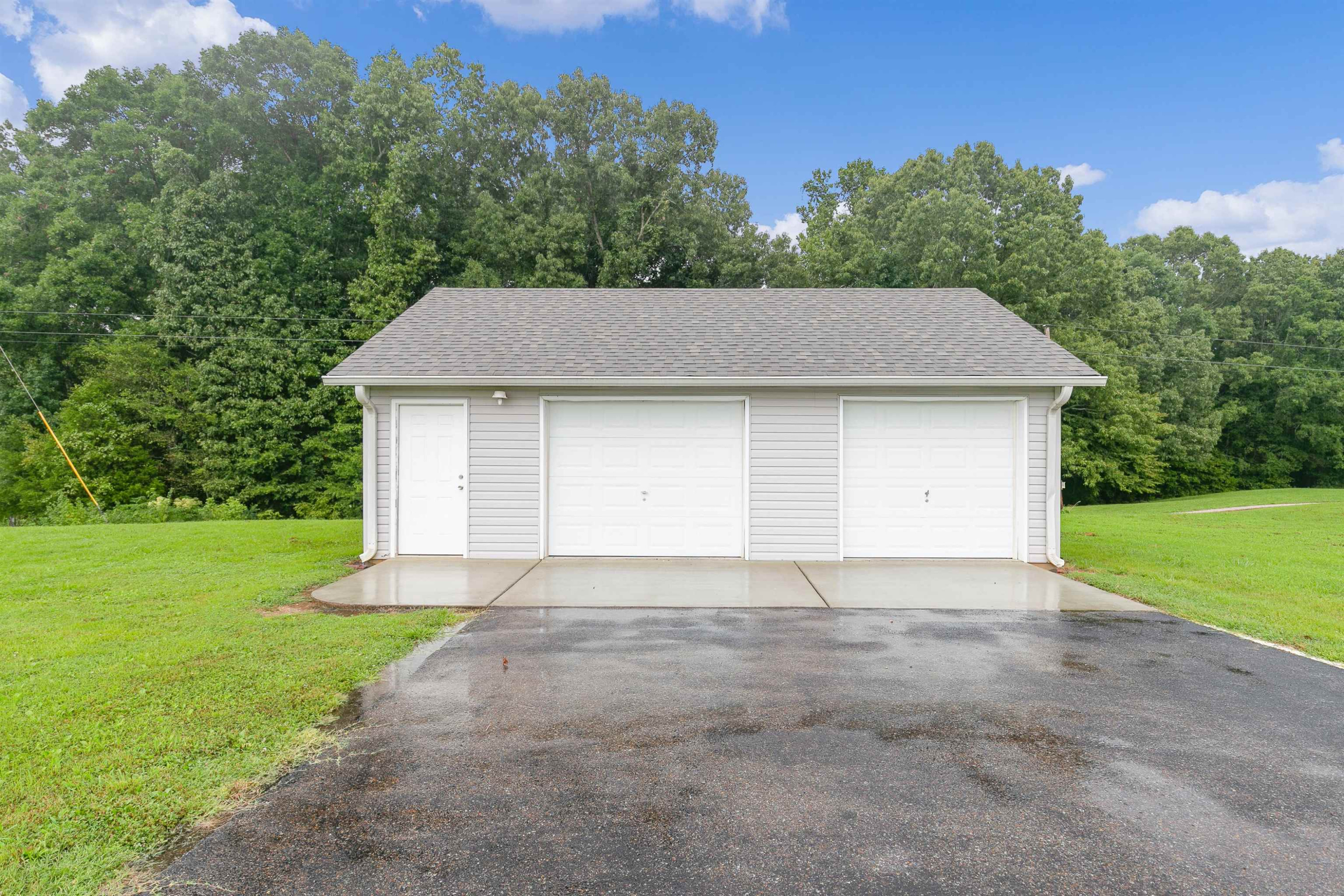 938 Cotton Grove Road Jackson, TN 38305 - Photo 19 of 24 a front view of a house with a yard and garage
