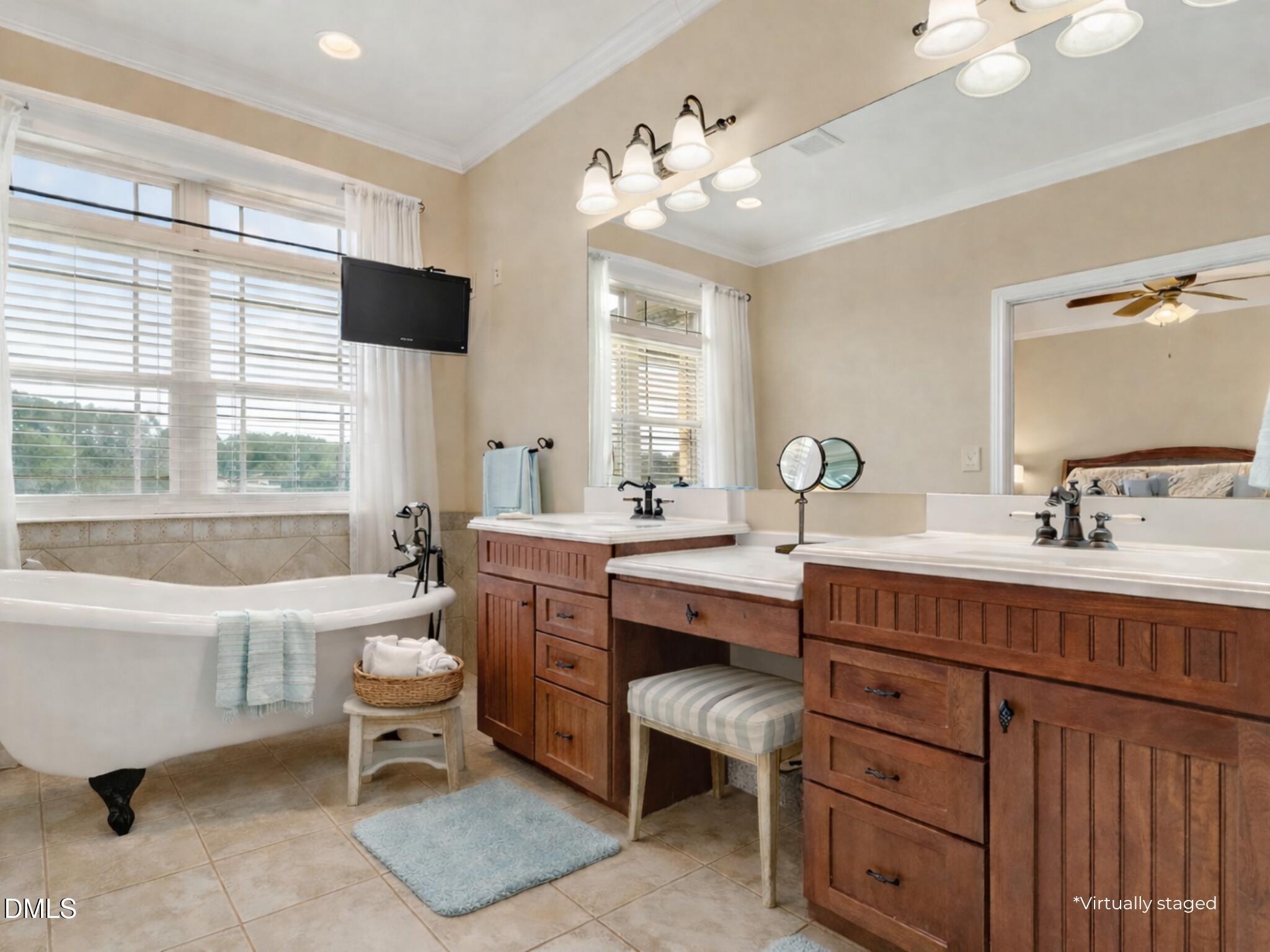 6570 Highway 231 Middlesex, NC 27557 - Photo 31 of 71 a bathroom with a double vanity sink a mirror and a bathtub