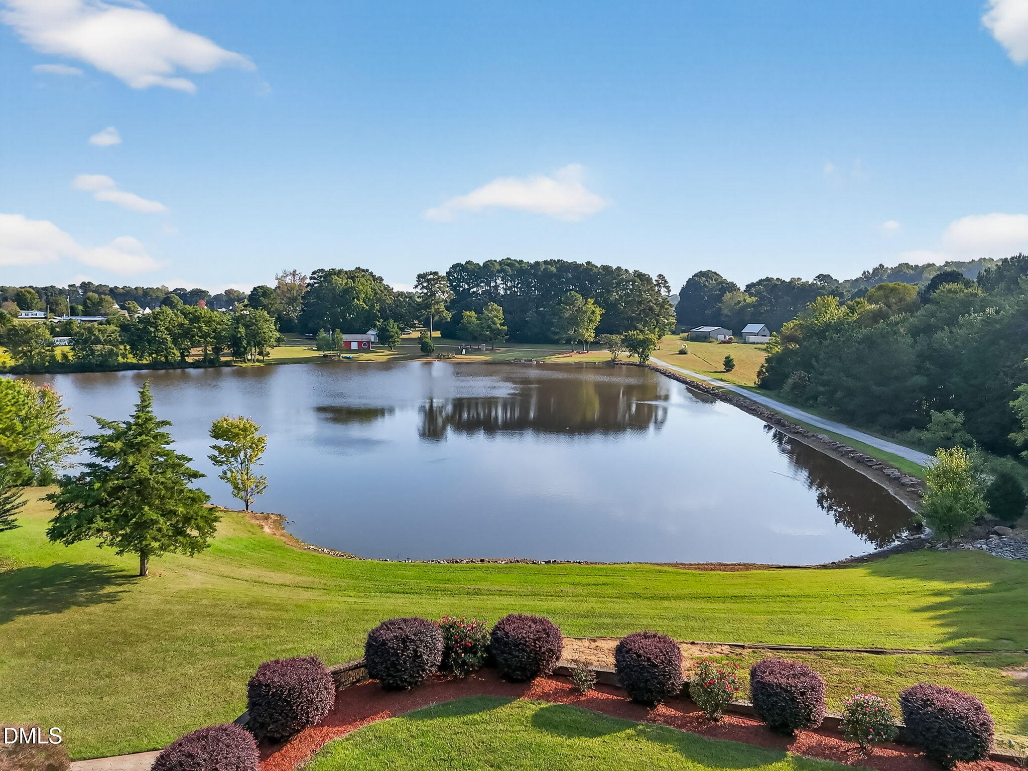 6570 Highway 231 Middlesex, NC 27557 - Photo 8 of 71 a view of a lake with a yard and outdoor seating