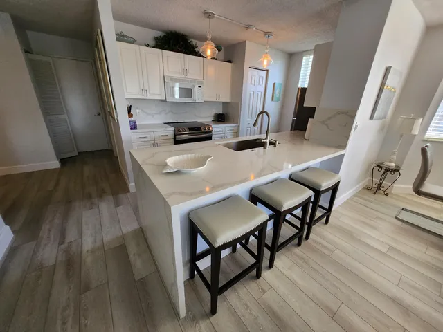 a living room with furniture a couch and wall painting