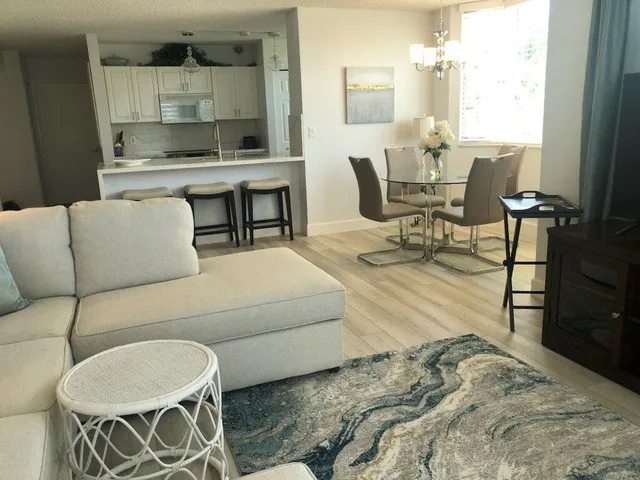 a living room with furniture a couch and wall painting