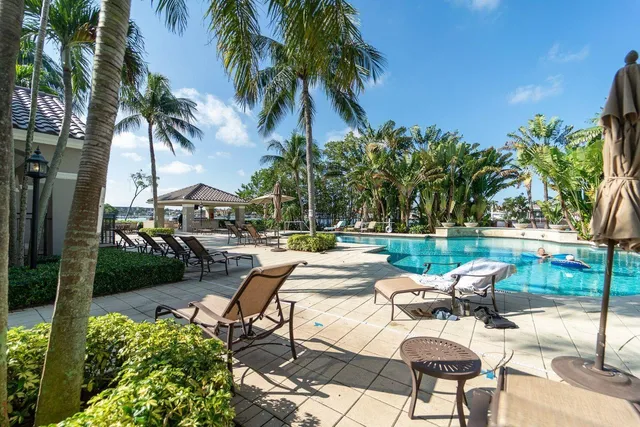 a view of a patio with couches and a table and chairs under an umbrella