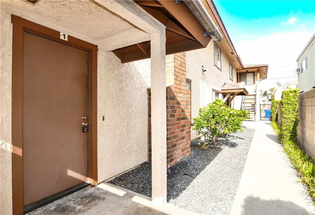 10515 Downey Avenue Downey, CA 90241 - Photo 4 of 6 a view of a entryway with a flower garden