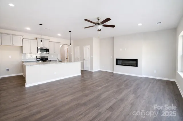 a view of a kitchen with wooden floor and a sink