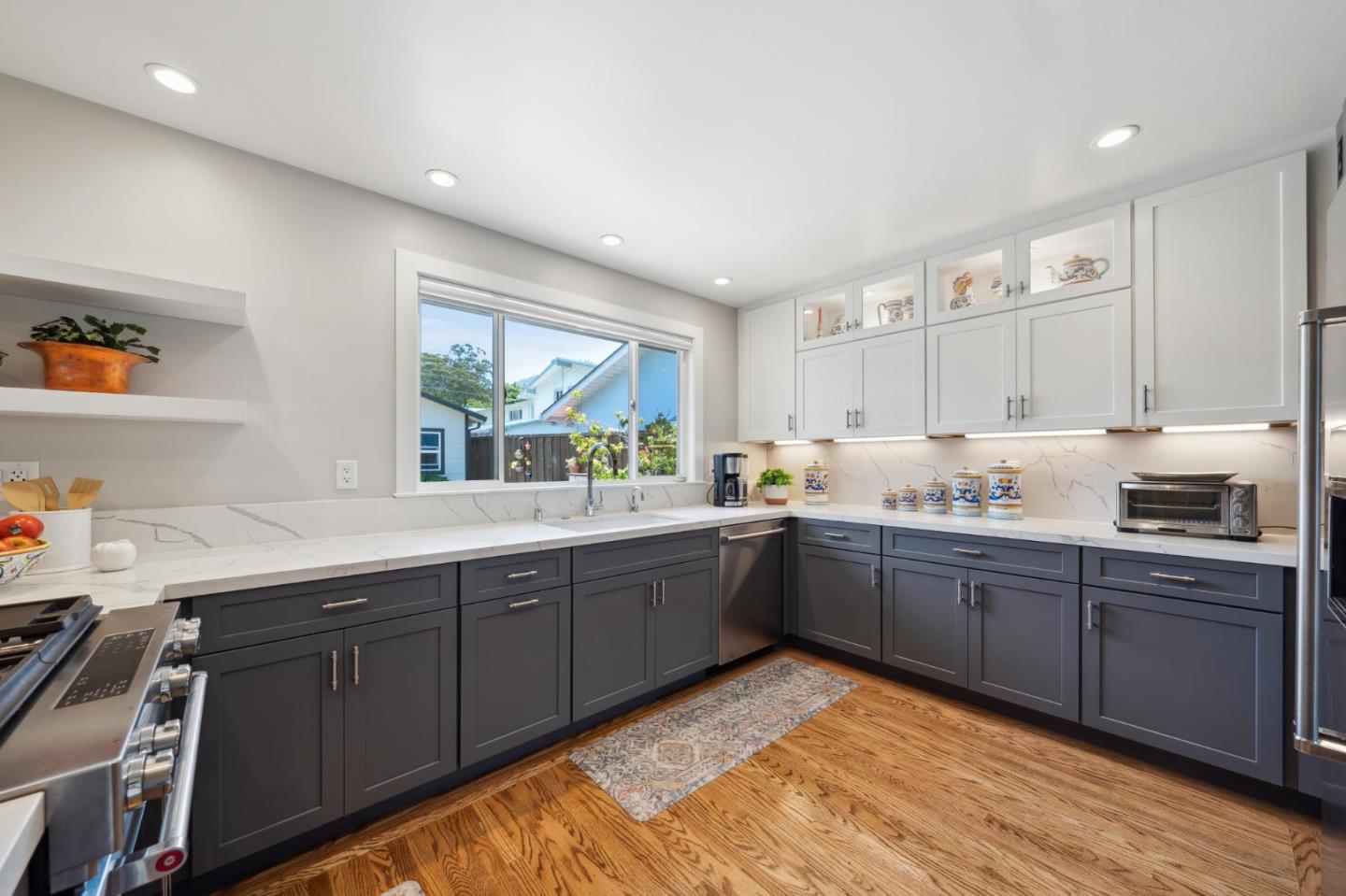 891 Standish Road Pacifica, CA 94044 - Photo 10 of 23 a kitchen with sink stove and cabinets