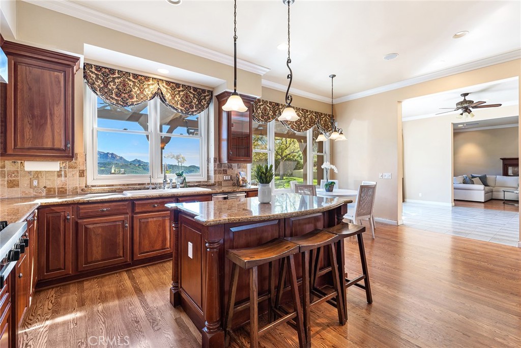 24920 Paseo Del Rancho Calabasas, CA 91302 - Photo 22 of 61 a kitchen with stainless steel appliances granite countertop wooden floor window and cabinets
