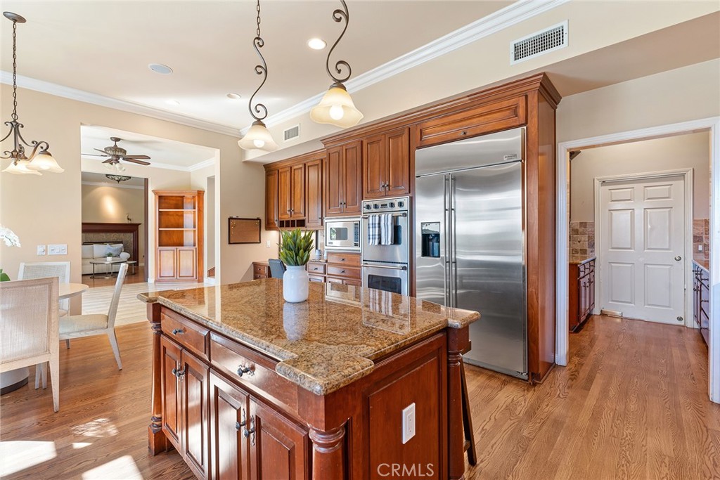24920 Paseo Del Rancho Calabasas, CA 91302 - Photo 23 of 61 an open kitchen with a table and refrigerator