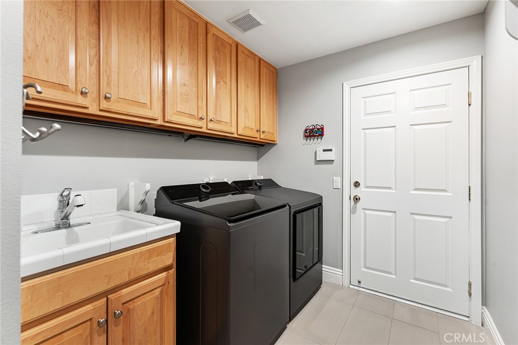 24920 Paseo Del Rancho Calabasas, CA 91302 - Photo 31 of 61 a utility room with sink dryer and washer