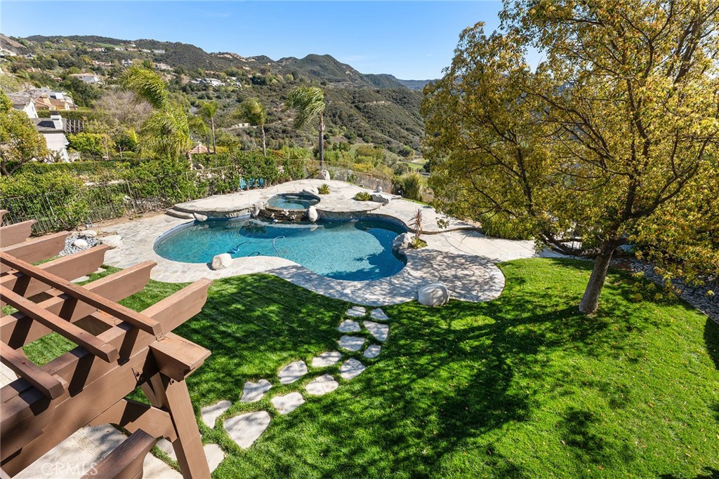 24920 Paseo Del Rancho Calabasas, CA 91302 - Photo 44 of 61 a backyard of a house with table and chairs
