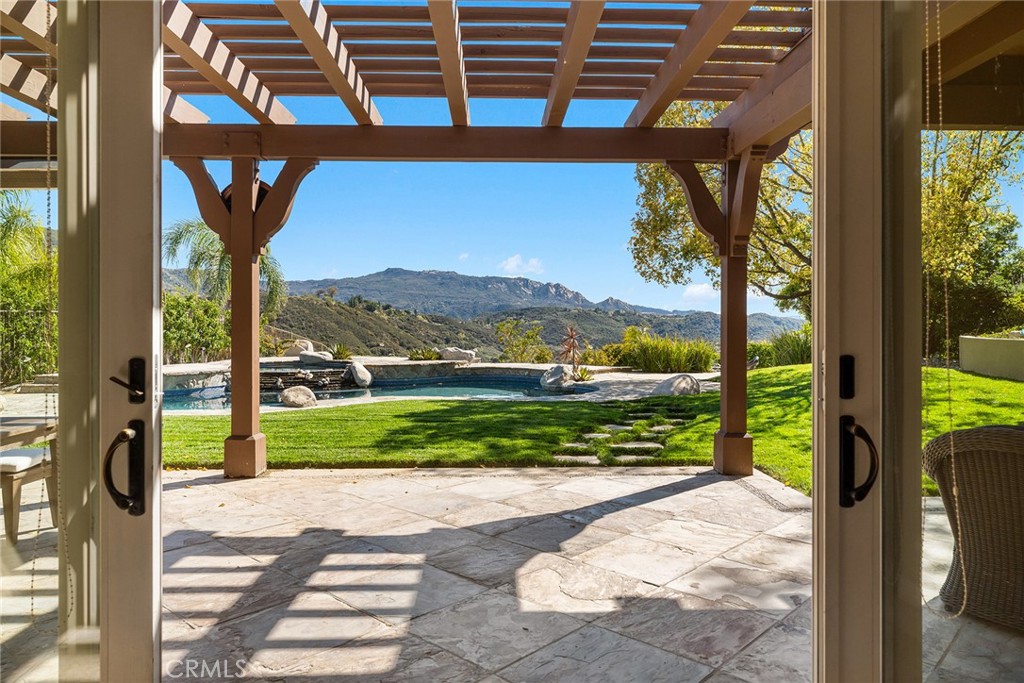 24920 Paseo Del Rancho Calabasas, CA 91302 - Photo 7 of 61 a view of a porch with a floor to ceiling window next to a yard