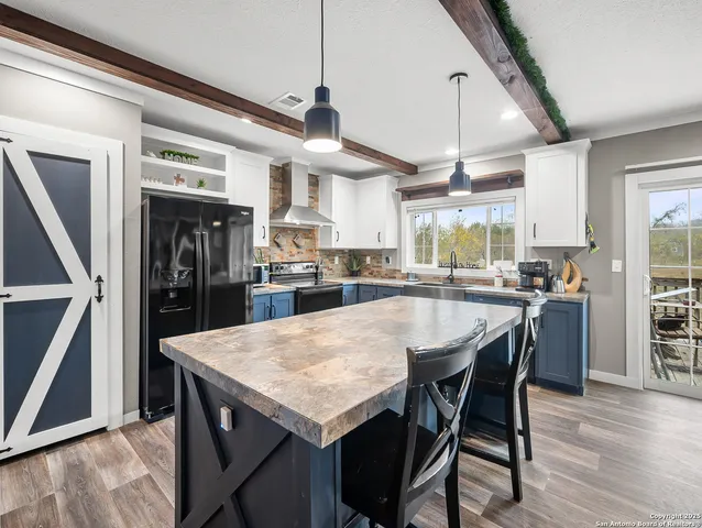 a large kitchen with a table and chairs
