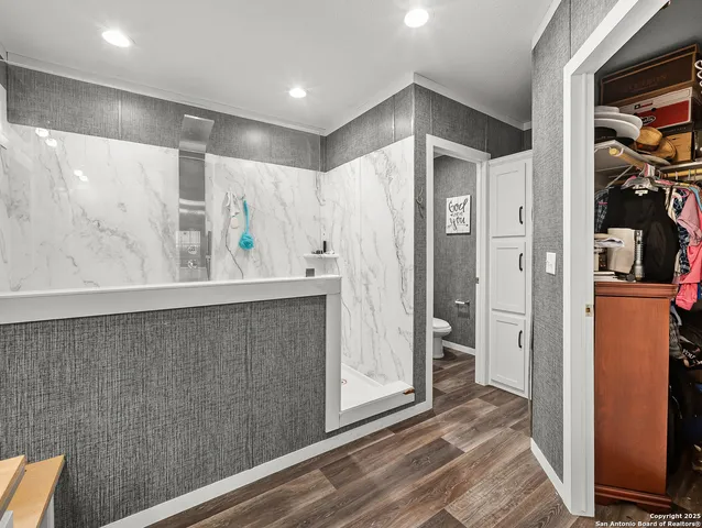 a view of a hallway with wooden floor and closet