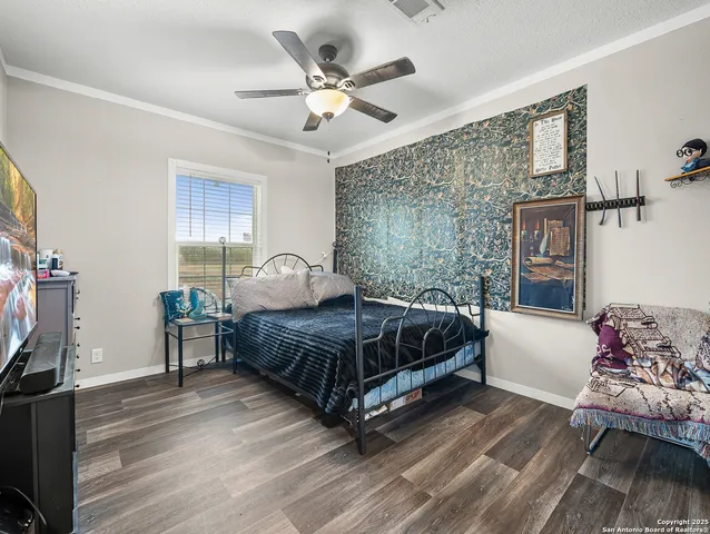 a bedroom with a bed window and a flat screen tv