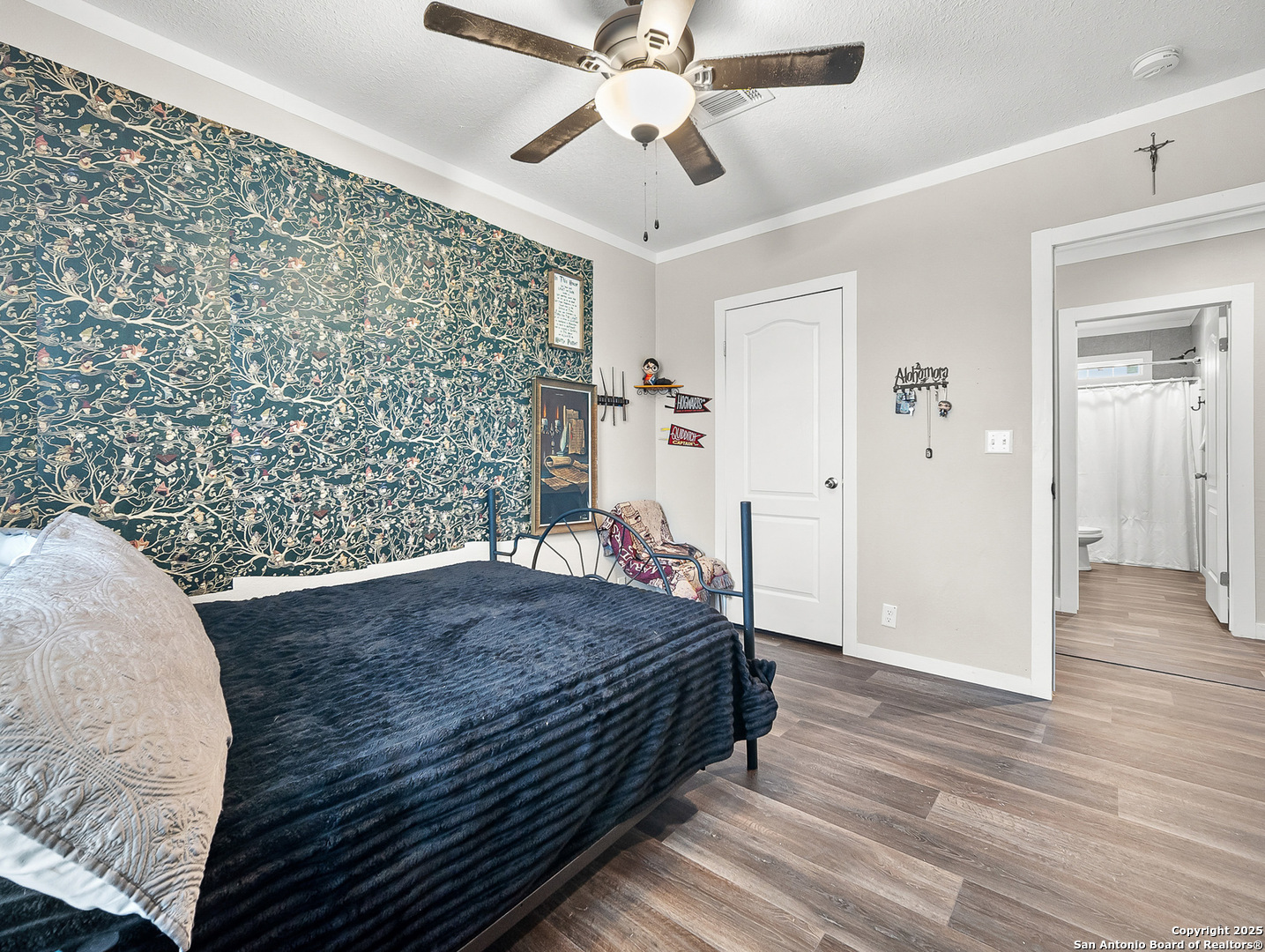 3809 Callihan Road Luling, TX 78648 - Photo 23 of 38 a spacious bedroom with a bed and a chandelier