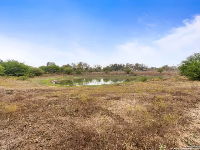 a view of a lake with houses in the background