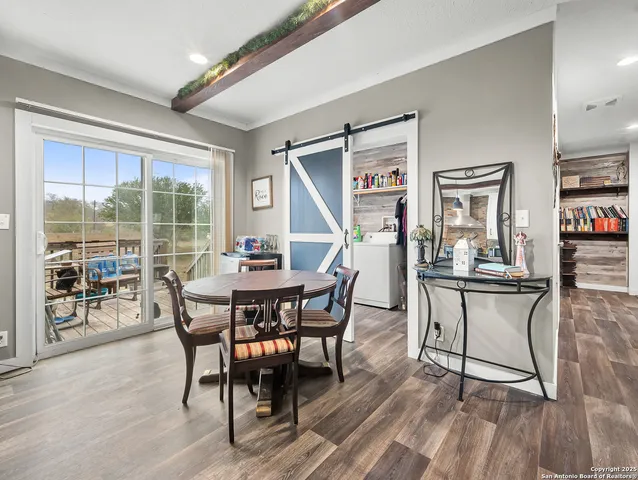 a dining room with furniture and wooden floor